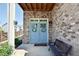 Charming brick home entry with a light blue double door adorned with wreaths and a bench at 351 Senna St, Marietta, GA 30064