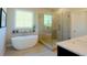 Spa-like main bathroom with a freestanding tub, glass-enclosed shower, and modern fixtures at 351 Senna St, Marietta, GA 30064