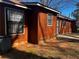 The home's exterior shows barred windows and doors at 4071 River Rd, Ellenwood, GA 30294