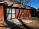 View of the home's exterior highlighting a concrete patio and sliding door to the home at 4071 River Rd, Ellenwood, GA 30294