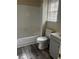 Bathroom with gray vanity, laminate flooring, and bathtub at 4071 River Rd, Ellenwood, GA 30294