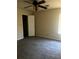 Comfortable bedroom featuring neutral walls, gray carpet, and ample closet space at 4071 River Rd, Ellenwood, GA 30294