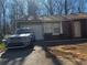 Exterior view of home with driveway and a silver Kia parked out front at 4071 River Rd, Ellenwood, GA 30294