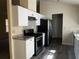 Modern kitchen featuring white cabinets, stainless steel appliances, and elegant granite countertops at 4071 River Rd, Ellenwood, GA 30294