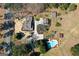 Aerial view of property featuring a home, pool, sheds, long driveway, landscaping, and mature trees at 813 Sandy Creek Rd, Fayetteville, GA 30214