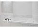 Elegant white bathroom features a luxurious soaking tub with marble-look detailing at 813 Sandy Creek Rd, Fayetteville, GA 30214