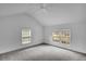 Bright bedroom with neutral carpet, vaulted ceiling, fan and views from double windows at 813 Sandy Creek Rd, Fayetteville, GA 30214