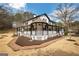 Charming two-story home with a covered porch, black shutters, white siding, and brick walkway at 813 Sandy Creek Rd, Fayetteville, GA 30214