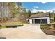 Detached two-car garage with a wide driveway and ample parking space, set in a serene landscape at 813 Sandy Creek Rd, Fayetteville, GA 30214