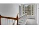 Bright hallway with natural light showcases staircase with wood and white railings at 813 Sandy Creek Rd, Fayetteville, GA 30214