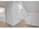 Bright hallway with white walls, wood-look flooring, and doors leading to different rooms at 813 Sandy Creek Rd, Fayetteville, GA 30214