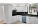 Well-lit kitchen features modern appliances, black backsplash, and white cabinets at 813 Sandy Creek Rd, Fayetteville, GA 30214