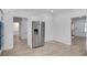 Open floor plan shows a large stainless refrigerator with bright kitchen and doorway to the entry at 813 Sandy Creek Rd, Fayetteville, GA 30214