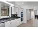 Well-designed kitchen features white cabinetry, black backsplash, and stainless steel appliances at 813 Sandy Creek Rd, Fayetteville, GA 30214