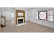 Comfortable living room with fireplace, lovely flooring, and a decorative stained glass window at 813 Sandy Creek Rd, Fayetteville, GA 30214