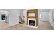 Spacious living room with hardwood flooring and a lovely fireplace between kitchen and staircase at 813 Sandy Creek Rd, Fayetteville, GA 30214