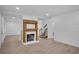 Open-concept living room with neutral paint, beautiful flooring and lovely fireplace at 813 Sandy Creek Rd, Fayetteville, GA 30214