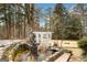 Backyard water feature with brick walkway, mature landscaping, and pergola at 813 Sandy Creek Rd, Fayetteville, GA 30214