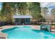 Beautiful in-ground pool with waterfall feature and pool house; great for outdoor fun at 813 Sandy Creek Rd, Fayetteville, GA 30214