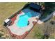 Aerial view of a fenced in-ground pool with diving board, cabana and concrete surround at 813 Sandy Creek Rd, Fayetteville, GA 30214