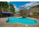 Large swimming pool with a pool house, waterfall feature, and meticulously kept grounds at 813 Sandy Creek Rd, Fayetteville, GA 30214