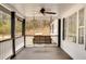 Relaxing front porch with a swing, offering serene views of the surrounding greenery and a cooling ceiling fan at 813 Sandy Creek Rd, Fayetteville, GA 30214