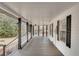 Inviting porch with black columns, providing a comfortable outdoor space with a view of the landscaped surroundings at 813 Sandy Creek Rd, Fayetteville, GA 30214