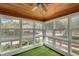 Bright sunroom with wrap around windows and wood ceiling overlooking a pond at 813 Sandy Creek Rd, Fayetteville, GA 30214