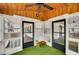 Cozy sunroom features wood paneling, bright windows, and a ceiling fan for year-round comfort at 813 Sandy Creek Rd, Fayetteville, GA 30214