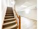 Staircase leading to finished basement with vinyl flooring at 1584 Hebron Ln, Riverdale, GA 30296