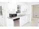 Well-lit kitchen featuring stainless steel dishwasher and ample counter space at 1584 Hebron Ln, Riverdale, GA 30296