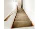 Staircase featuring neutral carpet steps and handrail at 1584 Hebron Ln, Riverdale, GA 30296
