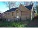 Picture of house with overgrown yard, boarded up windows, and damaged front entryway at 2055 Marco Dr, Decatur, GA 30032
