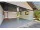 Large covered carport or garage with white walls and painted black ceiling at 4442 Mark Anthony Ct, Decatur, GA 30035