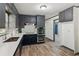 Updated kitchen with navy cabinets, stainless appliances, white countertops and wood look tile at 4442 Mark Anthony Ct, Decatur, GA 30035