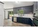 Stylish kitchen with wood look tile floor, navy cabinets, and stainless steel appliances at 4442 Mark Anthony Ct, Decatur, GA 30035