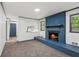 Living room with painted brick fireplace and view into the kitchen at 4442 Mark Anthony Ct, Decatur, GA 30035