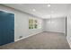Neutral living room featuring plush carpet, lots of natural light, and a modern light fixture at 4442 Mark Anthony Ct, Decatur, GA 30035