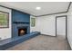 Living room with painted brick fireplace, carpet and two windows at 4442 Mark Anthony Ct, Decatur, GA 30035