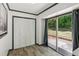 Room with tile flooring, sliding glass doors to the backyard, and closet with bifold doors at 4442 Mark Anthony Ct, Decatur, GA 30035