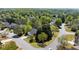 An aerial view of a neighborhood and landscaped yard with mature trees around a single-story home at 5755 Haterleigh Dr, Alpharetta, GA 30005