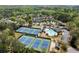 An aerial shot showcases a community featuring swimming pools, tennis courts, and well-maintained homes at 5755 Haterleigh Dr, Alpharetta, GA 30005