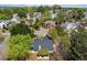 Aerial view of a neighborhood with lush landscaping and mature trees surrounding well-maintained homes at 5755 Haterleigh Dr, Alpharetta, GA 30005