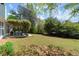 Expansive backyard featuring lush green lawn and a charming pergola-covered patio perfect for outdoor entertaining at 5755 Haterleigh Dr, Alpharetta, GA 30005