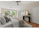 Bright bedroom with vaulted ceiling, ceiling fan, wood floors, and a view to the backyard at 5755 Haterleigh Dr, Alpharetta, GA 30005