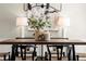 Dining table centerpiece with lamps and abstract art in a neutral, bright room at 5755 Haterleigh Dr, Alpharetta, GA 30005