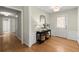 Inviting foyer with hardwood floors, a mirror, and views into the hallway and front door at 5755 Haterleigh Dr, Alpharetta, GA 30005