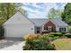 Charming single-story home featuring a brick accent, manicured landscaping and an attached two-car garage at 5755 Haterleigh Dr, Alpharetta, GA 30005