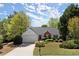 Charming one-story home featuring a brick accent, landscaped yard, and an attached two-car garage at 5755 Haterleigh Dr, Alpharetta, GA 30005