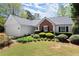 Charming single-story home with manicured landscaping, a brick accent, and an attached two-car garage at 5755 Haterleigh Dr, Alpharetta, GA 30005